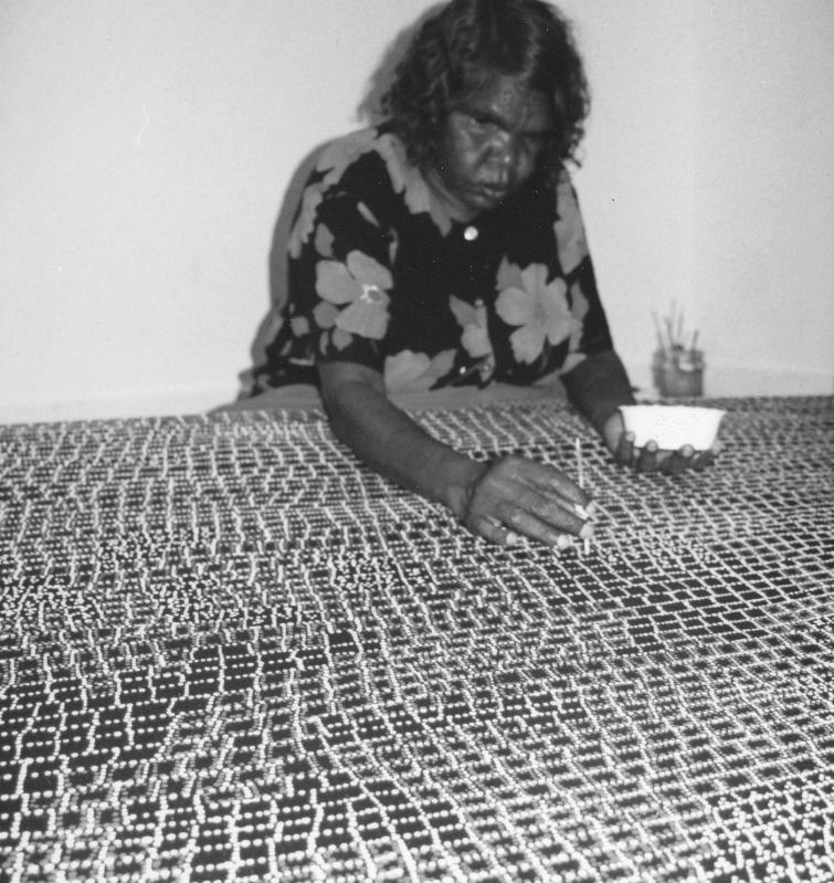Artist Dorothy Napangardi working on her canvas titled Karntakurlangu