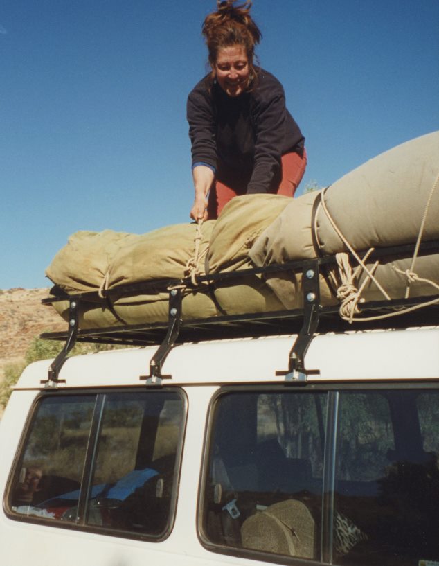 Roslyn Premont packing swags on the roof for a road trip
